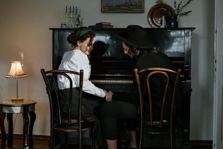 Intimate moment of a Jewish couple playing piano together in a cozy home setting, embracing love and tradition.